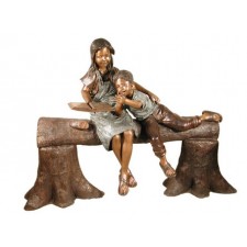 Boy and girl reading on log