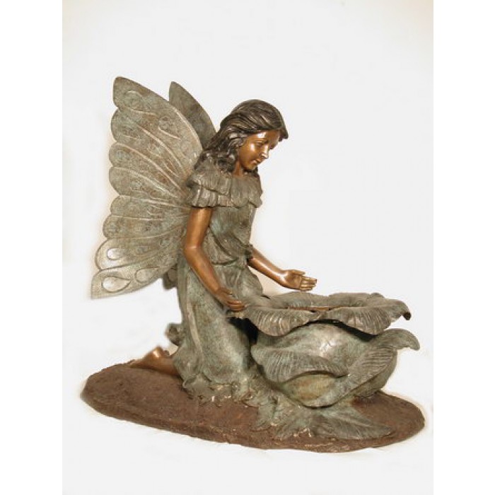 Angel kneeling by planter