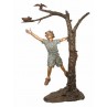 Boy reaching for bird on tree